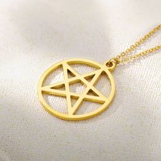 Unlock the mystical allure of our Pentagram Necklace, exquisitely forged in 14K solid gold. This captivating piece embodies strength, protection, and connection to the elements, making it more than just a piece of jewelry—it's a symbol of power. Crafted with precision, the pentagram pendant hangs gracefully on a delicate gold chain, offering a subtle yet profound statement. PRODUCT DETAILS: Choose of Material: 14K Solid Gold or 14K Gold Plated Closure: Spring ring Chain style: Cable Adjustable L Hypoallergenic 14k Gold Star Jewelry, Symbolic Rose Gold Brass Jewelry, Mystical Sterling Silver Gold Necklace, Gold Mystical Sterling Silver Necklace, Yellow Gold Star Of David Charms Jewelry, Spiritual Style Yellow Gold Metal Jewelry, Mystical 14k Gold Jewelry, Symbolic Yellow Gold Metal Jewelry, Symbolic Yellow Gold Jewelry