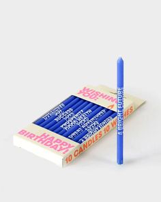 a blue pen sitting on top of a book with the words birthday written on it