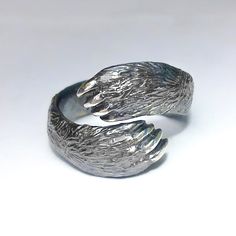 Stylish Silver Bear Paw ngRing fits on finger with circumferences from 6.5 to 15 size (US).Width: 0.28 in. or 7 mm.Material: • Silver 925.Bear MeaningThe bear has several meanings that will inspire those who have this animal as totem:The primary meaning of the bear spirit animal is strength and confidenceStanding against adversity; taking action and leadershipThe spirit of the the bear indicates it’s time for healing or using healing abilities to help self or othersThe bear medicine emphasizes t Bear Medicine, Dnd Clothes, Bear Spirit Animal, Bear Spirit, Bear Totem, Bear Ring, Healing Abilities, Unusual Wedding Rings, Paw Print Ring