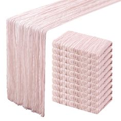 a stack of pink tissue sitting on top of a white table next to each other