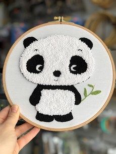 a panda bear embroidered onto an embroidery hoop