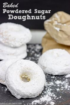 baked powdered sugar doughnuts on a baking sheet