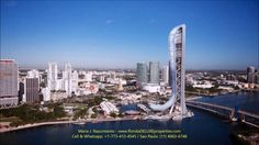 an aerial view of a city with tall buildings and a bridge in the middle of it