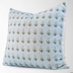 a blue pillow with cactus print on it