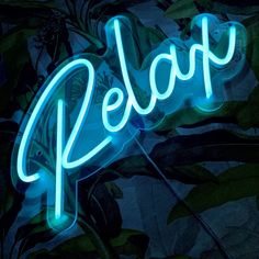 a neon sign that reads pepo on it's side in front of some leaves