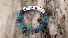 This beautiful bracelet is on a stretchy cord with the word Beauty and has the colors purple and blue. 💜💙 Trendy Personalized Purple Stretch Bracelet, Trendy Purple Stretch Bracelet With Letter Beads, Casual Purple Stretch Bracelet For Everyday, Purple Stretch Bracelet With Letter Beads For Gift, Purple Stretch Bracelet With Letter Beads As Gift, Personalized Adjustable Purple Stretch Bracelet, Casual Everyday Purple Stretch Bracelet, Colors Purple, Craft Corner