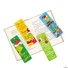 three bookmarks with the grin's christmas carols on them are sitting in front of an open book