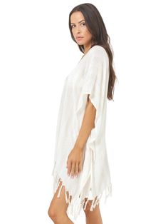 Effortlessly chic, L Space V-neck poncho offers a blend of style and comfort. With its waist tie and back-of-neck fastening, it ensures a secure fit while exuding bohemian charm with its playful tassel hem. Perfect for layering over your favorite swimsuit or pairing with denim for a laid-back beachside look.
 Size: XS/S, M/L Casual V-neck Beach Poncho, Casual V-neck Festival Cover-up, Chic Beige V-neck Cover-up, Casual Spring Poncho With Tassels, Spring Casual Tassel Kaftan, Casual Spring Kaftan With Tassels, Spring Vacation V-neck Poncho, Casual Beach Poncho With Tassels, Vacation V-neck Kaftan With Tassel Ties