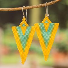 Something is calling for you in the merry Guatemalan region! Artisans from the Hands of Atitlan Association create these charming accessories that signal the direction to find your true essence. Made from glass beads, these triangular dangle earrings display a lovely combination of yellow and aqua hues, all dangling from sterling silver hooks that allow for comfortable use. Triangle Ear Wire Jewelry For Gifts, Yellow Teardrop Beaded Earrings With Dangling Beads, Handmade Triangle Earrings For Festival, Nickel-free Yellow Beaded Earrings As Gift, Summer Yellow Dangling Beads Earrings, Yellow Colorful Beaded Drop Earrings, Geometric Yellow Jewelry For Gifts, Unique Handmade Triangle Earrings, Nickel-free Yellow Dangle Beaded Earrings