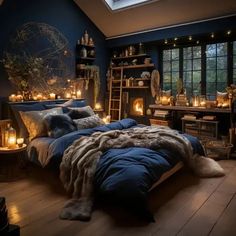 a bedroom with dark blue walls and wooden flooring is lit up by candle lights