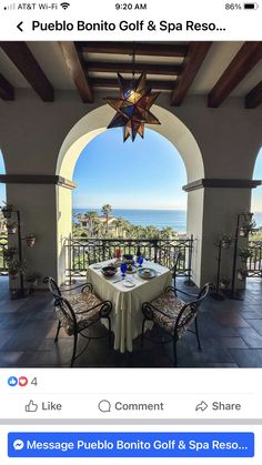 the table is set for two on the patio overlooking the ocean and beach in puerto