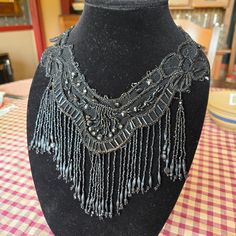 This is a vintage necklace or collar.  It is hand sewn onto black net. Believed to be from the 1930's to 1940's.  The condition is very good for it's age. The all black beads are glass.  9" fall from the shoulder to center front.  5.5" from the center neck to the center bottom.  3" drop at center back. Exquisite piece. Beaded Collar Necklace, Long Sleeve Evening Gowns, Beaded Collar, Wedding Jewellery Necklace, Collar Necklace, Hand Beading, Wedding Necklace, Black Beads, Wire Jewelry