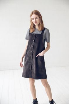 "DETAILS: * With two front pockets and buttons at full dress length * Short small apron dress suitable for all seasons * Made from 100 % cotton * Height of the model is 177 cm (5' 8\") and she is wearing size XS * The full dress length is 93 cm / 36.6'' * Color - black * Available in 2 colors. Please choose another color and size on the right * Product number: D16 CARE LABEL: * machine wash gentle (40 C/104 F) * dry gentle on low heat * wrinkles give the character so there is no need to iron, bu Sleeveless Cotton Apron With Pockets, Cotton Workwear Apron With Pockets, Cotton Apron With Pockets, Casual Cotton Apron With Pockets, Spring Workwear Pinafore Dress With Pockets, Spring Pinafore Dress With Pockets For Work, Casual Cotton Pinafore Dress With Bib Front, Casual Workwear Pinafore Dress With Buttons, Casual Pinafore Dress For Work With Buttons