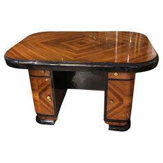 an art deco desk made out of wood and black lacquer with geometric design