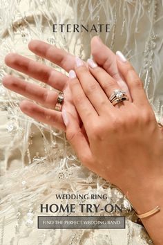 a woman's hand holding two wedding rings with the words, home try - on