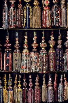 an assortment of beaded necklaces on display in a store