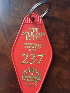 the overlook hotel keychain is red with gold lettering on it's side