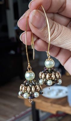 These are Indian style jewelries called Jhumka. Every single piece is handmade by me using high quality product such as beads from Miyuki, some hoops are 14 to 18 carat gold plated (the ones studded with zirconia diamond crystals), crystals are mainly from Czech from Periciosa. The  green bicone crystal Jhumka in this listing and the bronze pearl inside the bronze Jhumka are all Swarovski products. I buy the Swarovski gems from a major wholesalers here in Vancouver BC. Please note the hoop style Handmade Fusion Dangle Jhumkas, Handmade Fusion Style Dangle Jhumkas, Gold Earrings With Latkans And Round Beads, Festive Drop Earrings With Gold Beads, Handmade Gold Dangle Jhumkas, Gold Round Beaded Earrings With Spacer Beads, Handmade Gold Fusion Jhumkas, Traditional Gold Round Beaded Earrings, Elegant Round Beaded Earrings With Spacer Beads