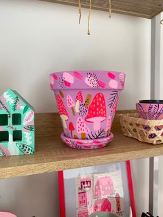 three bowls are sitting on a shelf next to each other in the shape of houses