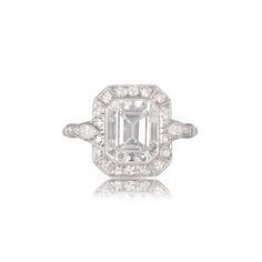 This is a GIA certified engagement ring that features a 2.60ct emerald cut diamond center. The diamond is decorated with a row of old cut diamonds around its center and two pear-shaped diamonds on the shoulders. ✦DIAMOND SPECIFICATIONS: Center Diamond Size: 2.60-Carats Diamond Color: H Color Diamond Clarity: VS2 Clarity Diamond-Cut: Emerald Cut ✦ ENGAGEMENT RING SPECIFICATIONS: Style: Vintage Ring Material: Platinum Certification: GIA ✦ WHAT COMES IN YOUR SHIPMENT: - Your Engagement Ring - Quali Gia Certified Timeless Octagon Emerald Ring, Gia Certified Octagon Emerald Ring, Gia Certified Emerald Cut Cluster Promise Ring, Classic Octagon Emerald Ring In Platinum, Gia Certified Square Cut Moissanite Diamond Ring, Platinum Emerald Ring With Diamond White Center Stone, Platinum Emerald Cut Emerald Ring With Diamond Cut, Radiant Cut Emerald Ring In Platinum, Emerald Cut Emerald Ring With Diamond Cut In Platinum