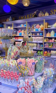 the candy shop is filled with lots of colorful candies and lollipops