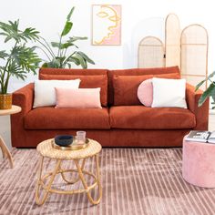 a living room filled with furniture and plants