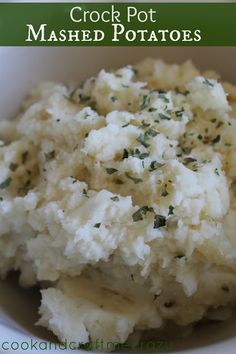 mashed potatoes in a white bowl with herbs on top and the words crock pot mashed potatoes above it