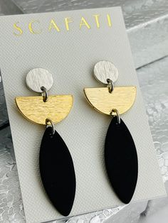 "The round textured posts are rack plated with a silver alloy which is a combination of base metals. Rack plating means that the pieces are hand hung so they receive the optimal amount of coverage. The half circle for this earring is offered in 2 different finishes: White Silver Alloy over Brass 18 K Gold over Brass Extended from the half circles is black sea glass which is a nice contrast to either silver or gold. All metals used are lead safe. The full length of the earrings including the post Geometric Earrings Minimalist, Half Circle Earrings, Nice Jewelry, Black Polymer Clay Earrings, Patina Earrings, Black And White Earrings, Circle Jewelry, Earthy Jewelry, Diy Earrings Polymer Clay