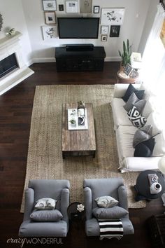 an overhead view of a living room with couches, coffee table and television set