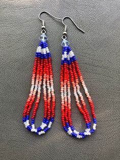 Handmade earrings. Native American beaded earrings made with true cut size 11 seed light blue bicone bead topper. colors are Pink,white (AB)pearl  coral, different shades of red, dark blue. They measure about 3.5 inches long with a stainless steel earwire hooks. I now offer free shipping on orders $35.00 and over! I mail packages Monday through Friday except on holidays. please ask any question that you may have. Different Shades Of Red, Native American Beaded Earrings, Native American Beading, Bead Leather, Shades Of Red, Chandelier Earrings, Handmade Earrings, Pink White, Native American