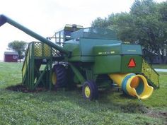 a large green machine is in the grass