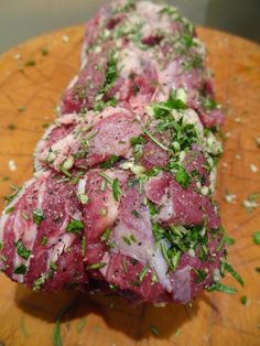 raw meat with herbs and seasoning on a cutting board