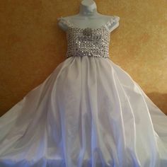 This "Illusion Rhinestone Look" Sequin & Taffeta Ballgown Set Is Available By Custom Order In Your Choice Of Size And Color. Color Options Are Subject To Availability. Fabrics & Trim Style Will Vary/Differ Based Upon Availability. Please Allow 1 To 2 Weeks For Production Before This Item Ships. This Item Is A Final Sale. No Returns, Refunds, Exchanges Allowed. Absolutely No Exceptions Made. The Sample Gown Sets Are Available To Ship Within 4 Business Days, To Be Sold As Is. Elegant Floor-length Pageant Dress For Wedding, Elegant Floor-length Wedding Pageant Dress, Embellished Organza Ball Gown For Wedding, White Satin Wedding Dress With Detachable Train, Wedding Pageant Dress With Embellished Fitted Bodice, Embellished Pageant Dress With Fitted Bodice For Wedding, Fitted Organza Pageant Dress For Wedding, Pageant Ball Gown Wedding Dress With Fitted Bodice, Pageant Gown With Detachable Train And Fitted Bodice