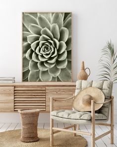 a living room with a chair, table and large flower on the wall above it