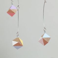 the earrings are made with multicolored geometric shapes