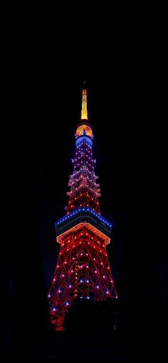 the eiffel tower is lit up in red, white and blue