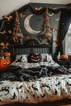 a bedroom decorated in black and white with pumpkins on the bed, halloween decorations