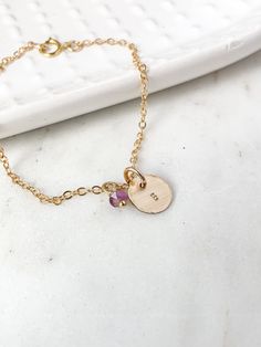 This personalized gold charm initial birthstone bracelet features a custom hand stamped gold charm. Makes a beautiful kids initial monogram bracelet for mom as well as a custom dainty gold layering bracelet bridal party gift for your bridesmaids, best friend gift or birthday gift for any lady in your life or treat yourself to a little sparkle. ♥︎  Made of 14k gold chain with a spring ring clasp and a 14k gold filled 13mm round disc charm. The charm can be personalized with any initial of your ch Dainty Charm Bracelet For Personalized Gift, Personalized 14k Gold Charm Bracelet Gift, Adjustable Hypoallergenic Initial Pendant Jewelry, Personalized Yellow Gold Charm Bracelet Adjustable, Personalized Yellow Gold Charm Bracelet With Adjustable Fit, Dainty 14k Gold Personalized Charm Bracelet, Personalized Dainty Name Bracelet, Dainty Personalized 14k Gold Charm Bracelet, Personalized Adjustable Yellow Gold Charm Bracelet