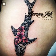 the back of a woman's shoulder with flowers on it and an antelope