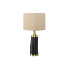 a black and gold table lamp with a beige shade on the top, against a white background