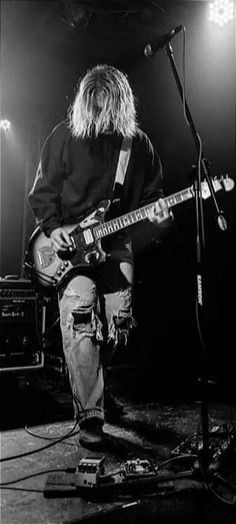 black and white photograph of a man playing guitar