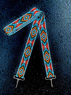 a pair of colorful beaded lanyards on a black surface