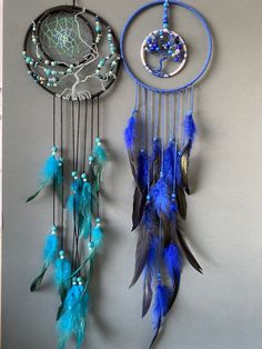 two dream catchers hanging on the wall next to each other with beads and feathers