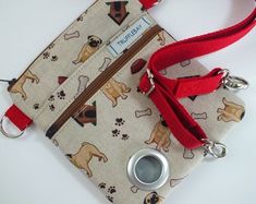 a small purse with a dog print on it and a red leash hanging from the front