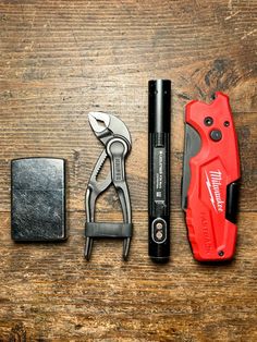 the tools are laying out on the wooden table, ready to be used as gadgets