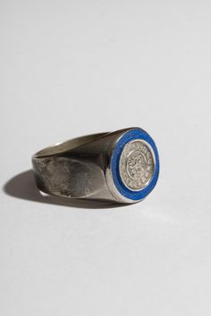 A sterling Mexican coin is surrounded by a ring of blue enamel on this sturdy signet ring. Sterling Silver + Blue Enamel Please note, this item is final sale. Garden Clogs, Silver Signet Ring, Enamel Jewelry, Ring Sterling Silver, Silver Blue, Women Accessories Jewelry, Signet Ring, Earring Necklace, Accessories Shop