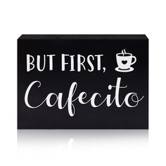 a black box sign that says but first, caffetto with a cup of coffee on it