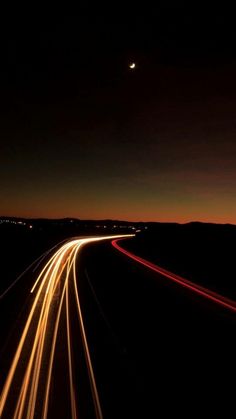 the night sky is lit up with long exposure and light streaks as seen from an airplane