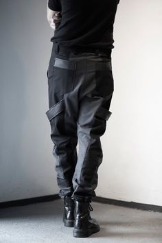 Dark gray & black pants designed with fake leather stripes, pockets front and back. Normal wash. Collection 'DISTRESSOR' Spring '21 Cyberpunk Black Pants With Side Pockets, Black Cyberpunk Pants With Side Pockets, Urban Fitted Parachute Pants With Belt Loops, Fitted Urban Parachute Pants With Belt Loops, Urban Fitted Parachute Pants, Cyberpunk Style Baggy Black Bottoms, Cyberpunk Black Bottoms With Multiple Pockets, Baggy Black Cyberpunk Bottoms, Winter Techwear Fitted Cargo Pants