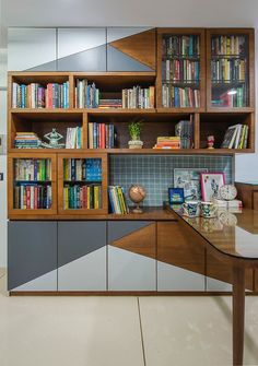 an office with bookshelves and desk in the center, along with several other items